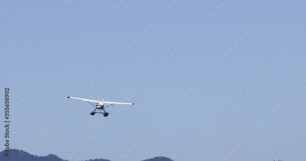 Seaplane flies away at Canada's west coast in Tofino on Vancouver Island. Seaplane flies away at Canada's west coast in Tofino on Vancouver Island.