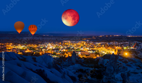 Goreme Village at dusk on the background Lunar eclipse and Blood Moon at night "Elements of this image furnished by NASA "