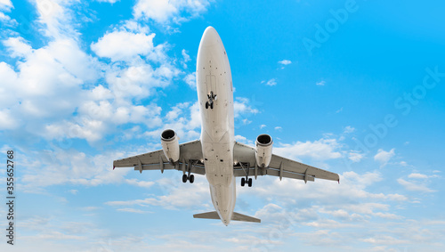 White Passenger plane fly up over take-off runway - White passenger airplane in the clouds - Travel by air transport
