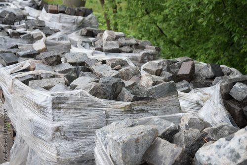 The stone is in huge packages. Selling and buying. Natural stone, construction. Paving.