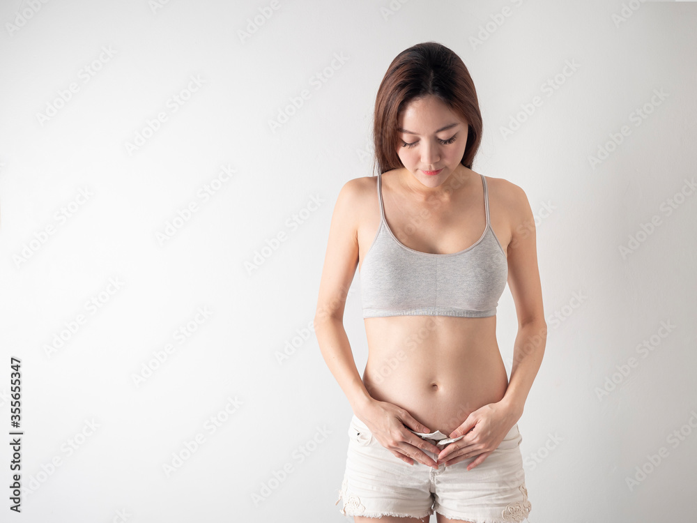 Studio Portrait of 2 months Pregnant Woman on white background. Studio Portrait of 2 months Pregnant Woman on white background.
