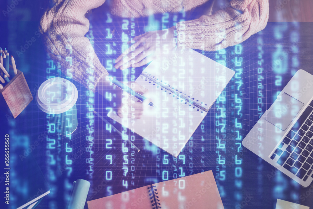 Obraz premium Double exposure of writing hands on background with data solution hologram on front. Technology concept. Close up