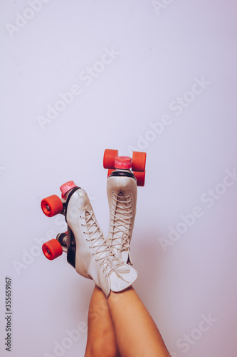 girl with legs up wearing a white 70s roller skates photo