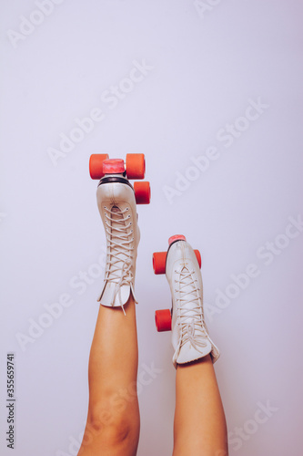 girl with legs up wearing a white 70s roller skates
