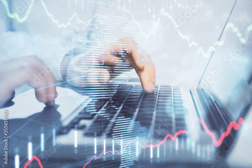 Wallpaper Mural Double exposure of market chart with man working on computer on background. Concept of financial analysis. Torontodigital.ca