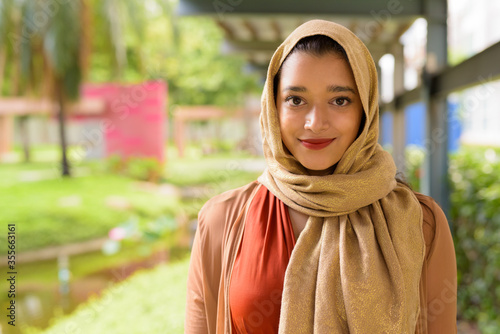 Photography Face of young beautiful Indian Muslim woman at the park outdoors