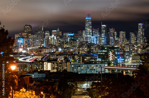 San Francisco California USA - August 17, 2019: San Francisco city skyline panorama at night viewed from Potrero Hill on the crossing of Texas street and 19th street © Andrey