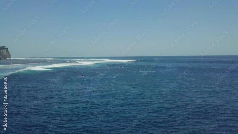 Surfer riding and turning with spray on powerful ocean wave. Surfing ocean lifestyle, extreme sports, aerial tracking cinematic shot. Surfer riding and turning with spray on powerful ocean wave. Surfing ocean lifestyle, extreme sports, aerial tracking cinematic shot.