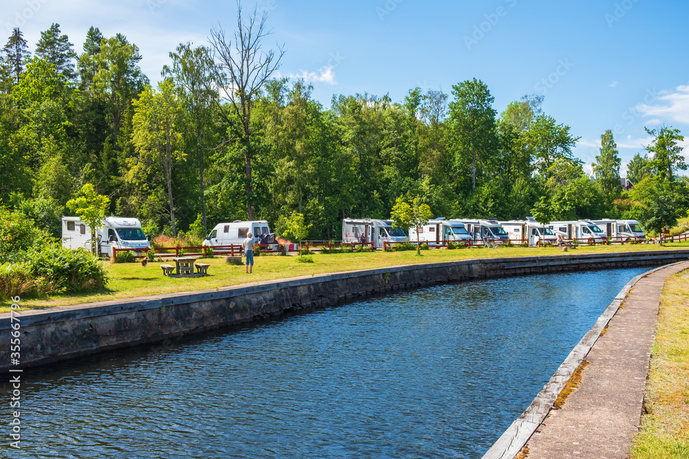 Canal with motorhomes in a parking lot