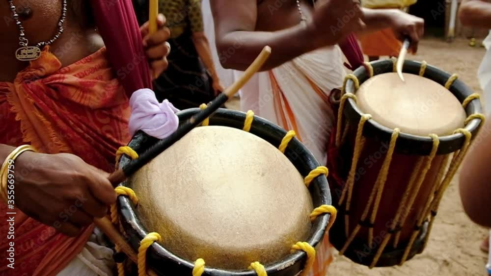 Indian men play traditional percussion drum Chenda in Kerala, India