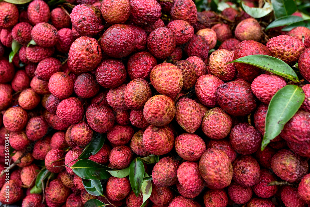 Lychee, Fresh lychee showing the red skin and with green leaf .selective focus. Lychee, Fresh lychee showing the red skin and with green leaf .selective focus.