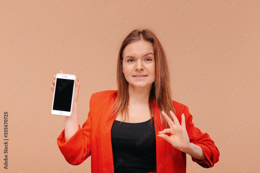 A young girl shows a blank smartphone screen.