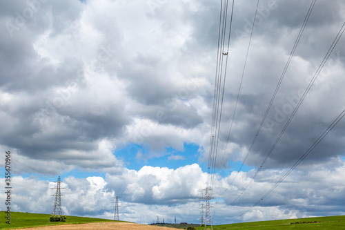Картината върху платно Electricity pylons in the Sussex countryside, with dramatic clouds overhead