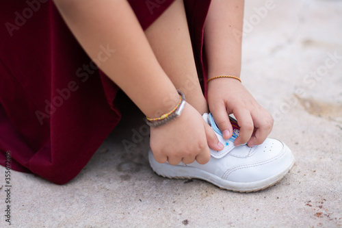 The girl is wearing white shoes to go to exercise.