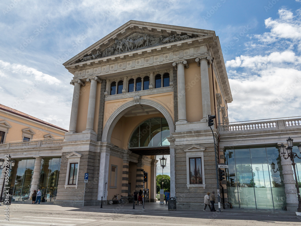 adua, entrance of new restorated Foro Boario parking at daytime with no cars in the street, near Prato della Valle square, with blue sky with some clouds