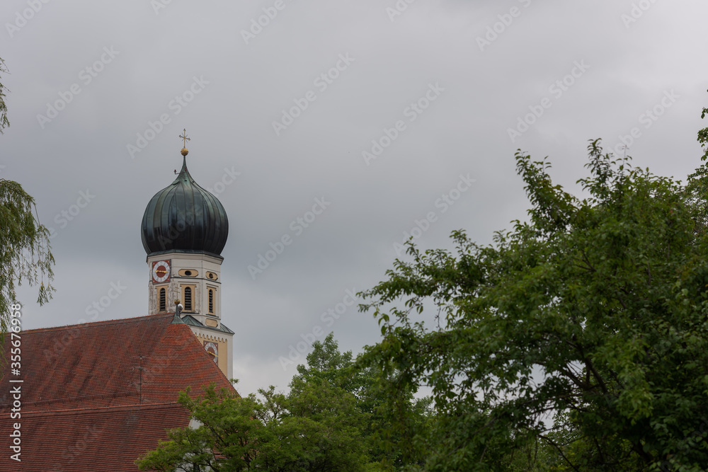 Tower top of the church of Holy Maria Magdalena in the bavarian town Fuerstenfeldbruck on cloudy overcast day