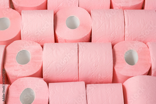 Rolls of pink toilet paper. Abstract background or texture. Large number of rolls of pink toilet paper