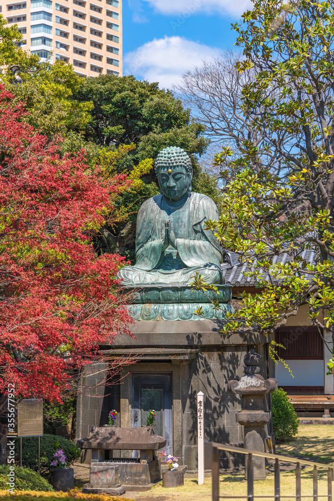 Bronze statue of Buddha Shaka Nyorai with a stone lantern and the sentence May Peace Prevail On Earth on a Peace Pole Project's pole in the Tennoji temple of Yanaka. Bronze statue of Buddha Shaka Nyorai with a stone lantern and the sentence May Peace Prevail On Earth on a Peace Pole Project's pole in the Tennoji temple of Yanaka.