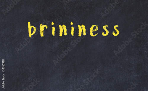 College chalk desk with the word brininess written on in