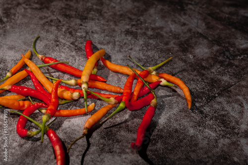 Multicolored peppers on a black background. It's spicy. Hot spicy food concept and Top view. There's a copy space.