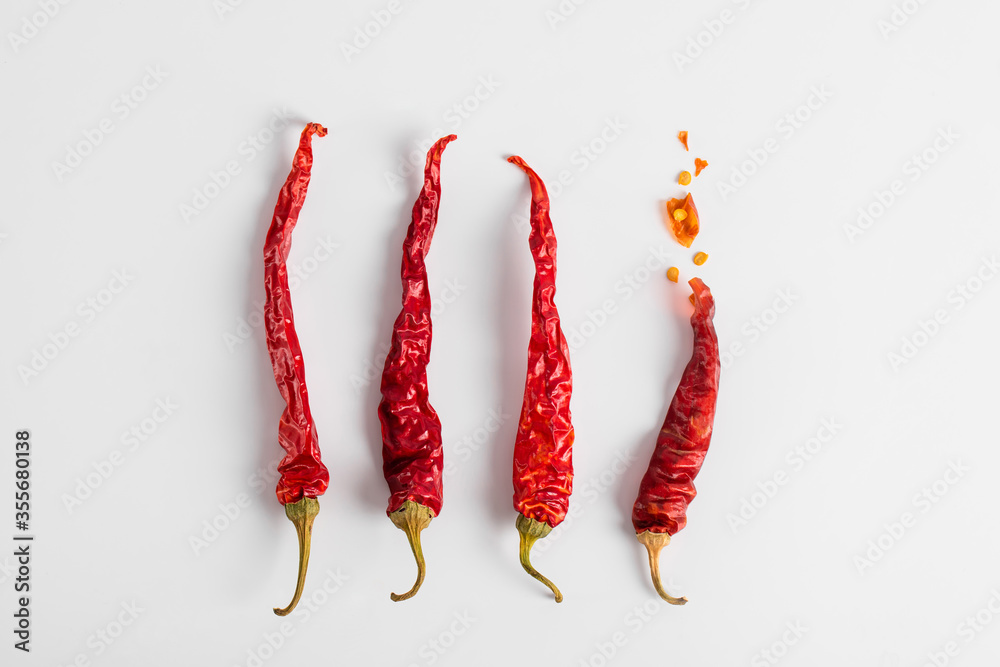 Dried red chili peppers on a white background. Dry vegetables. Dried red chili peppers on a white background. Dry vegetables.