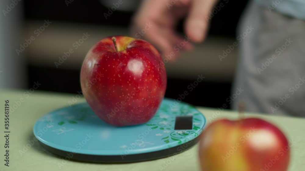custom made wallpaper toronto digitalHand of a man weighs several red apples on a kitchen scale, close-up