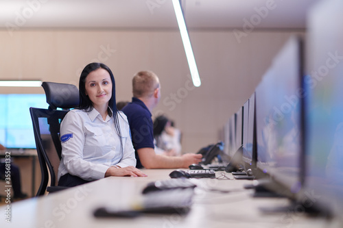 Female operator working in a security data system control room