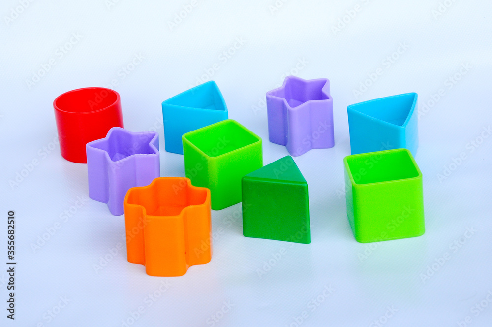 Isolated children's toy blocks in various shapes made of plastic on white background Isolated children's toy blocks in various shapes made of plastic on white background