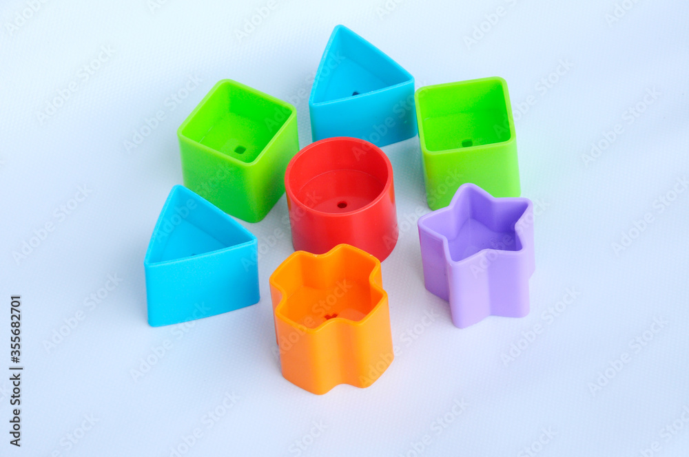Fototapeta premium Isolated children's toy blocks in various shapes made of plastic on white background 