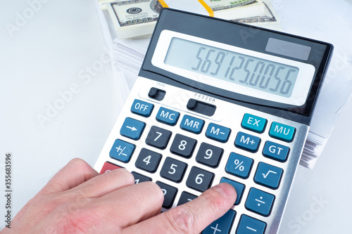 Man counts money using a ca...
