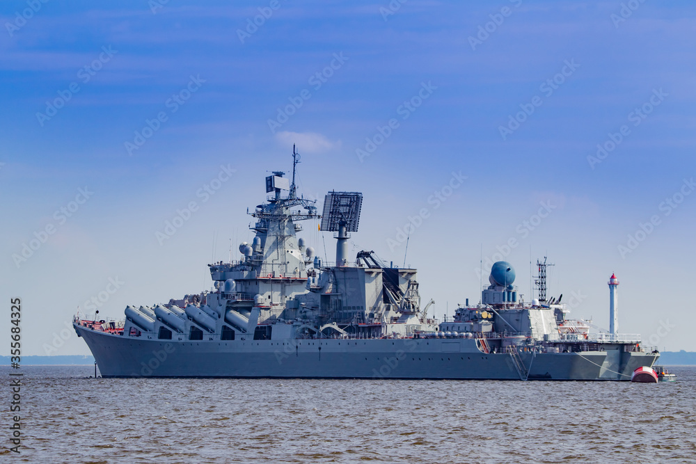 A warship is sailing in the sea. Missile cruiser against the sky. Weapons Russian warship view from afar. Naval forces. Russian weapons. Kreser 