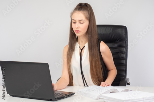 A woman works at an office ...