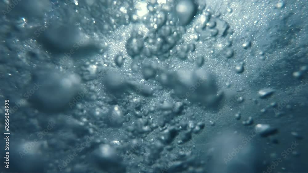 Underwater Bubbles with sunlight through water surface, natural slow motion underwater scene