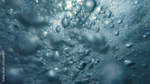 Underwater Bubbles with sunlight through water surface, natural slow motion underwater scene