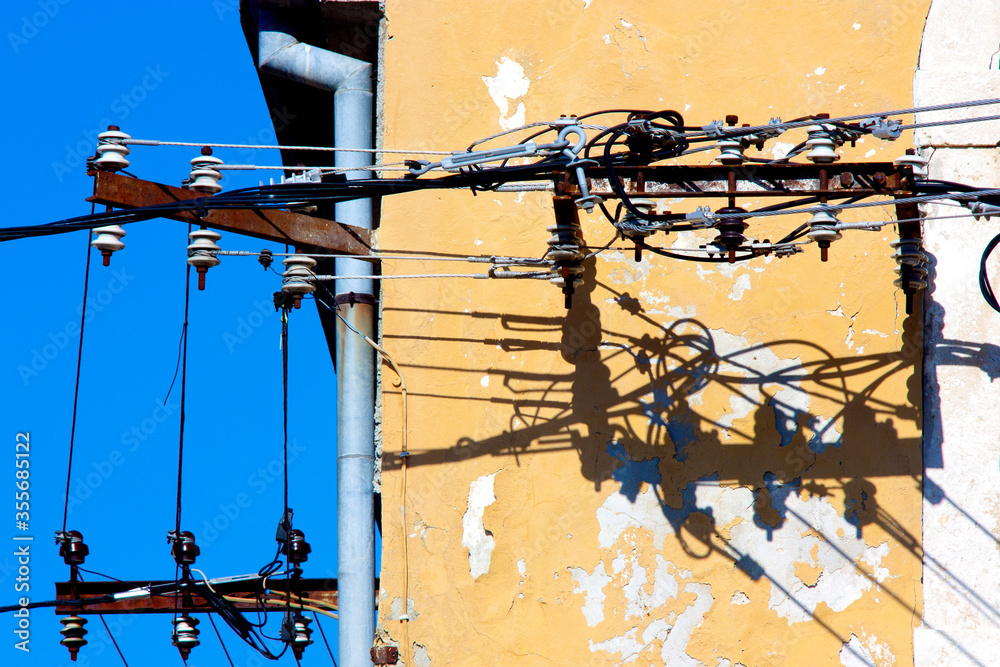 Old electricity cables and their shadow