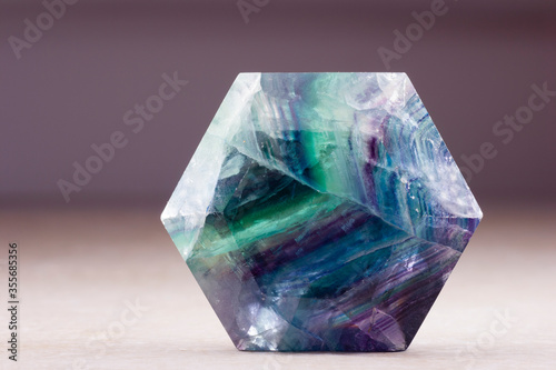 polished flourite crystal in the shape of hexagon
