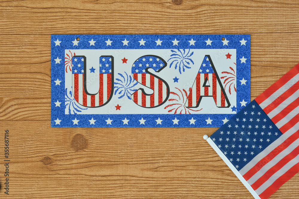 Obraz premium Independence Day July 4th, President's Day, Memorial Day, Labor Day, Veteran's Day, Great America. USA sign in the colors of the flag of the United States on a wooden background with the flag.