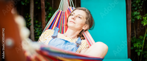 woman relaxing in hammock summer at home