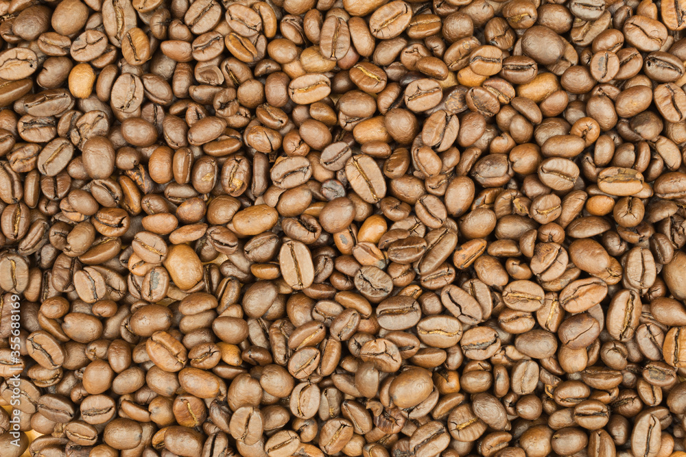 Coffee beans scattered around the table Coffee beans scattered around the table