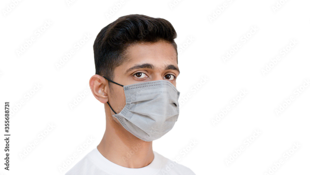 Young man looking in camera wearing face mask to protect himself from corona virus covid 19 Young man looking in camera wearing face mask to protect himself from corona virus covid 19