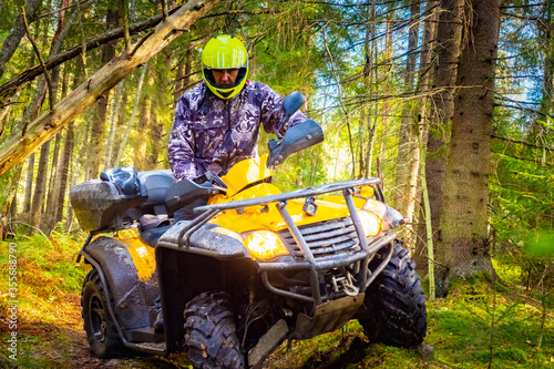 A man in a yellow helmet on the ATV close-up. Riding a Quad bike