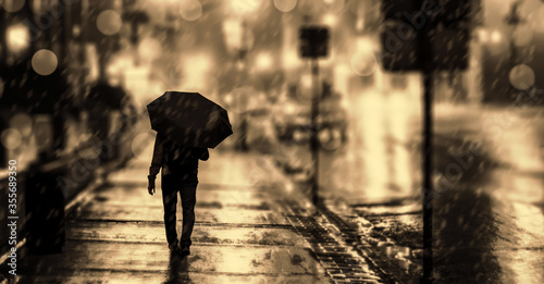 A man with an umbrella on the city street.