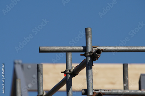 Scaffolding poles against a blue sky