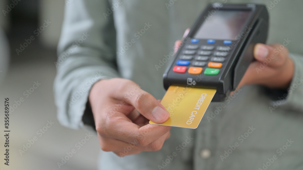 Close - up shot of Employees accept credit card payments via EDC. Close - up shot of Employees accept credit card payments via EDC.