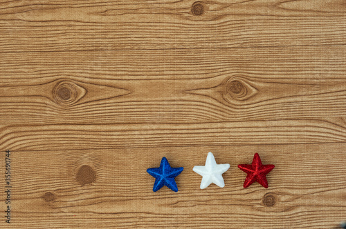 Independence Day July 4th, President's Day, Memorial Day, Labor Day, Veteran's Day, Great America. Blue, white and red stars in representation of the united states flag colors on a wooden background.