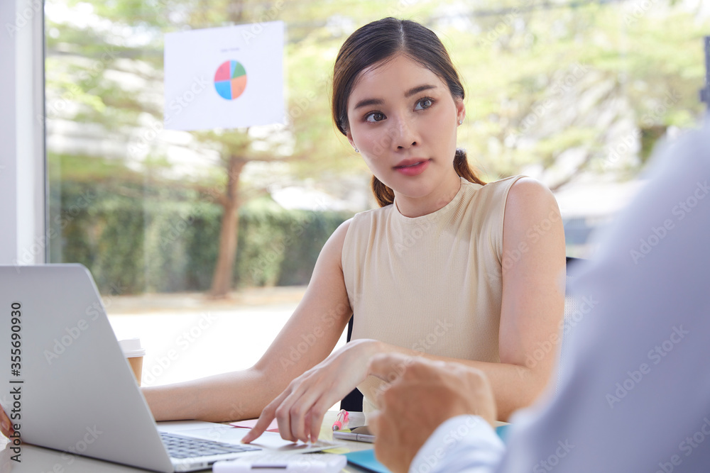 Smiling young female manager presenting business plan to investor. Beautiful business lady showing papers to businessman. Business meeting and negotiation concept Smiling young female manager presenting business plan to investor. Beautiful business lady showing papers to businessman. Business meeting and negotiation concept