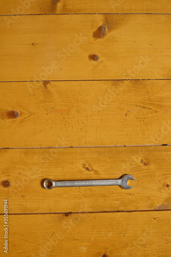 Wrench over wooden surface with copy space.