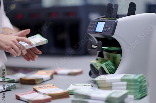 Bank employees sorting and counting paper banknotes © .shock