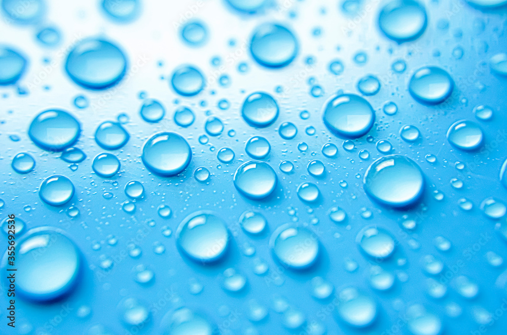 Beautiful big alcohol droplets on the light blue background. 