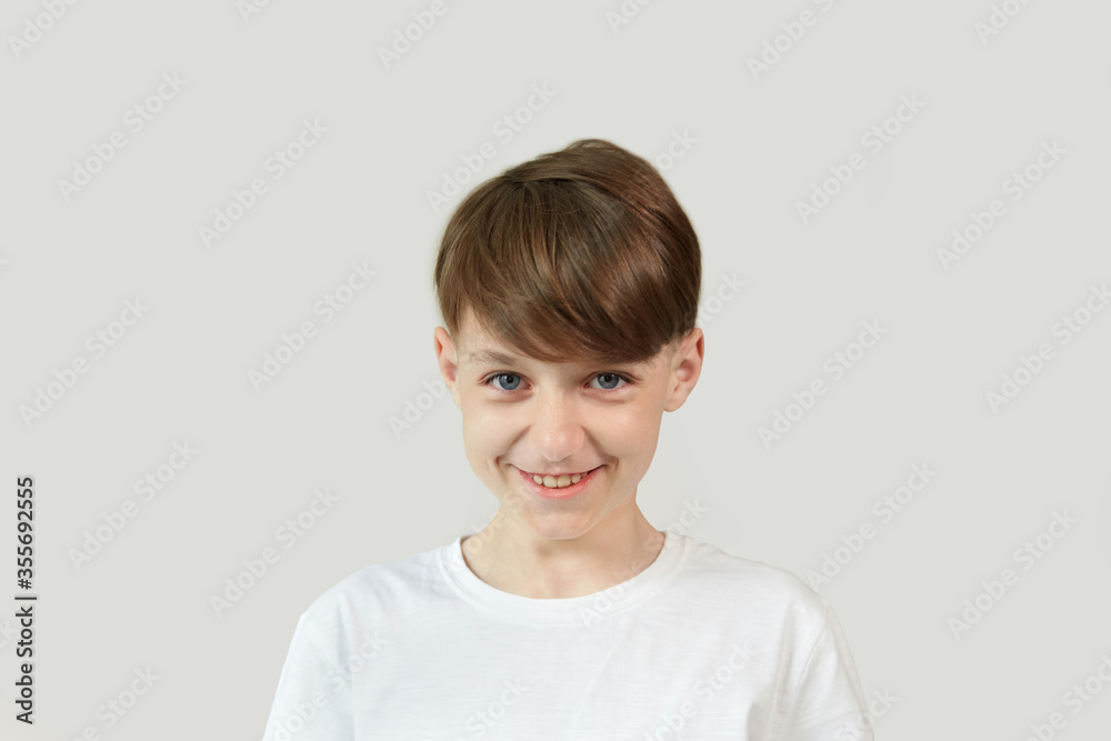 Smiling boy Caucasian appearance and with dark hair looks into the camera. Smiling boy Caucasian appearance and with dark hair looks into the camera.